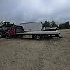red 2001 International 4700/ Century Tilt Load