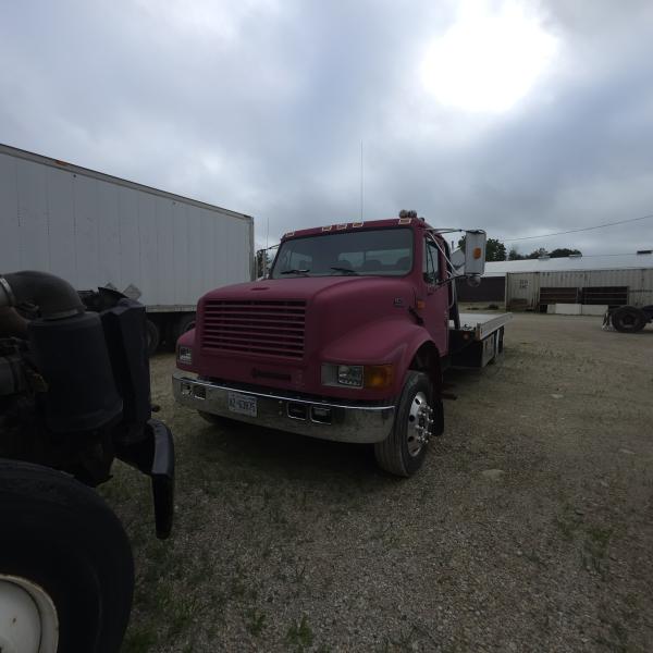 red 2001 International 4700/ Century Tilt Load